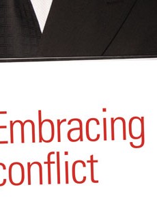 man with a sign 'embracing conflict'