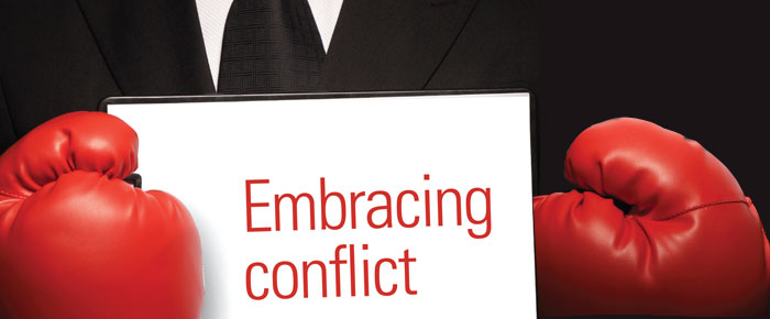 man with a sign 'embracing conflict'