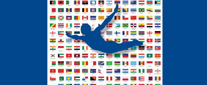 Person diving image with a background of flags throughout the world, ACAMS Today